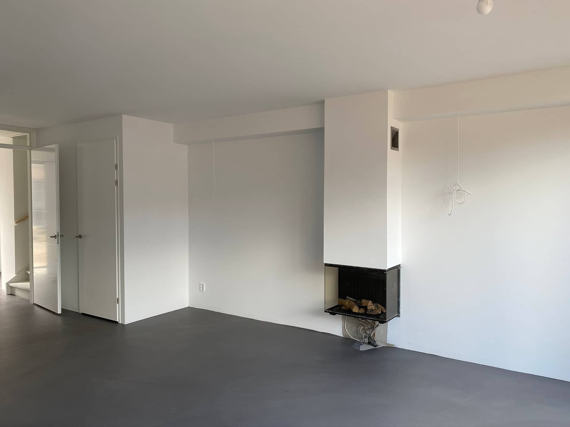 Renovlies nieuwbouw Utrecht: voorbeeld woonkamer met haardblok
